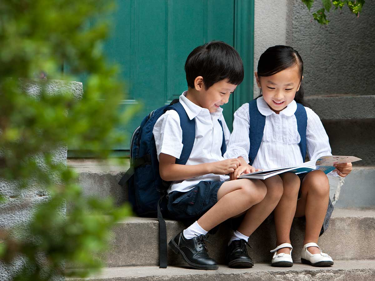 two-school-children-studying-outside.jpg